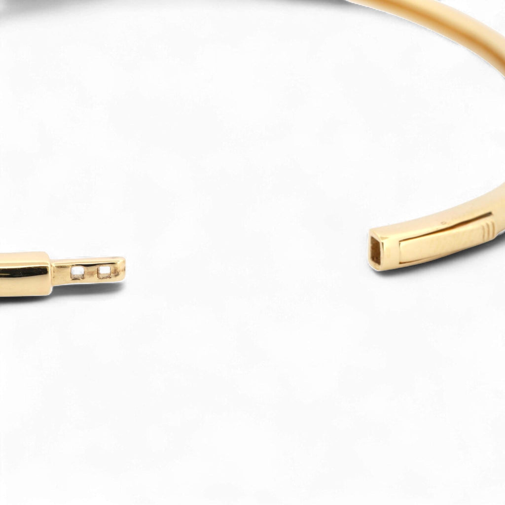 31 Jewels Inc. Effy 14K yellow gold bangle bracelet showing the open hinged push-slide clasp mechanism