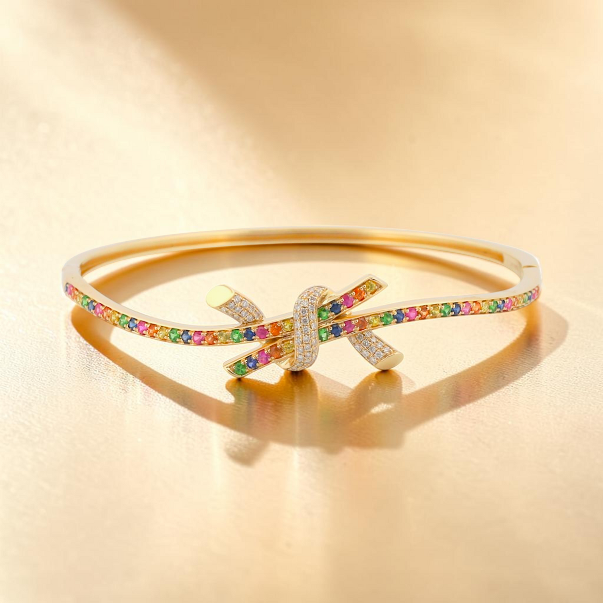 31 Jewels Inc. Effy 14K yellow gold ribbon twist bangle featuring pavé diamonds and multi-color sapphires.