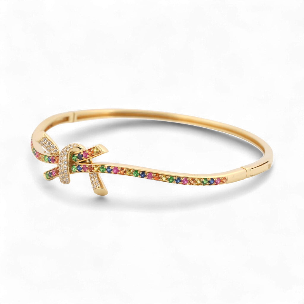 31 Jewels Inc. Effy 14K yellow gold ribbon twist bangle featuring multi-color sapphires and pavé-set diamonds.
