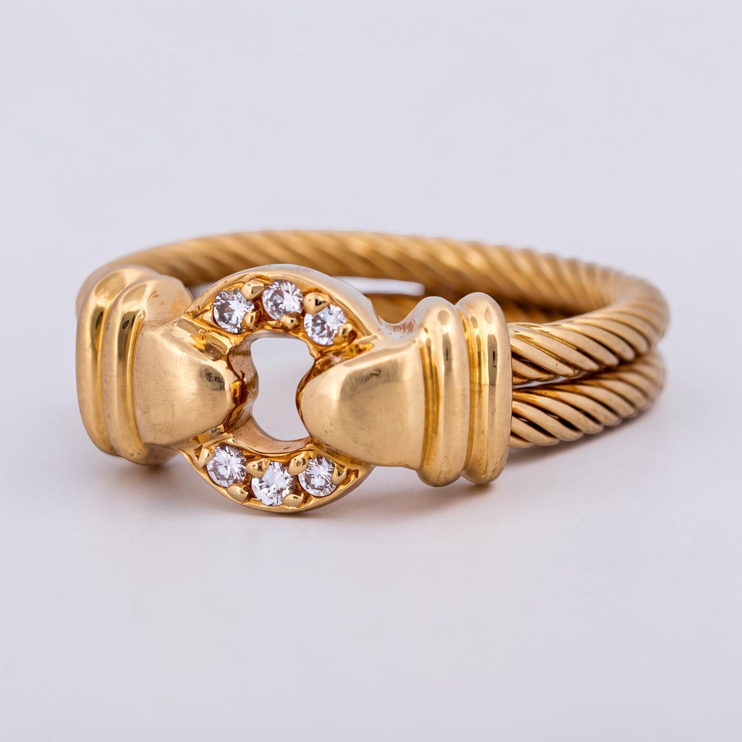 31 Jewels Inc. Philippe Charriol cable ring in 18k yellow gold with a diamond-accented centerpiece.